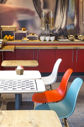 A dining area with a table, chairs, and a counter with various items.