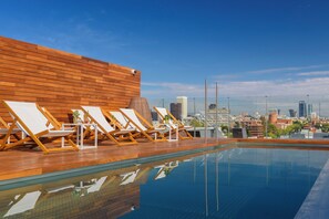 Seasonal outdoor pool, open noon to 7:00 PM, pool umbrellas