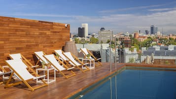 Seasonal outdoor pool, open noon to 7:00 PM, pool umbrellas