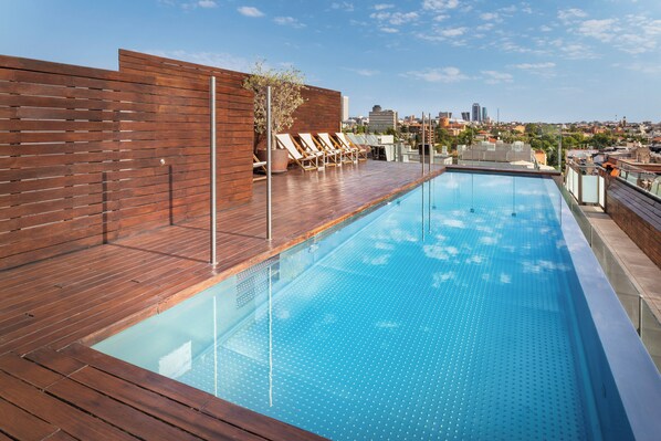 Seasonal outdoor pool, open noon to 7:00 PM, pool umbrellas