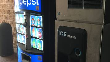 A vending machine with a Pepsi logo and an ICE dispenser.