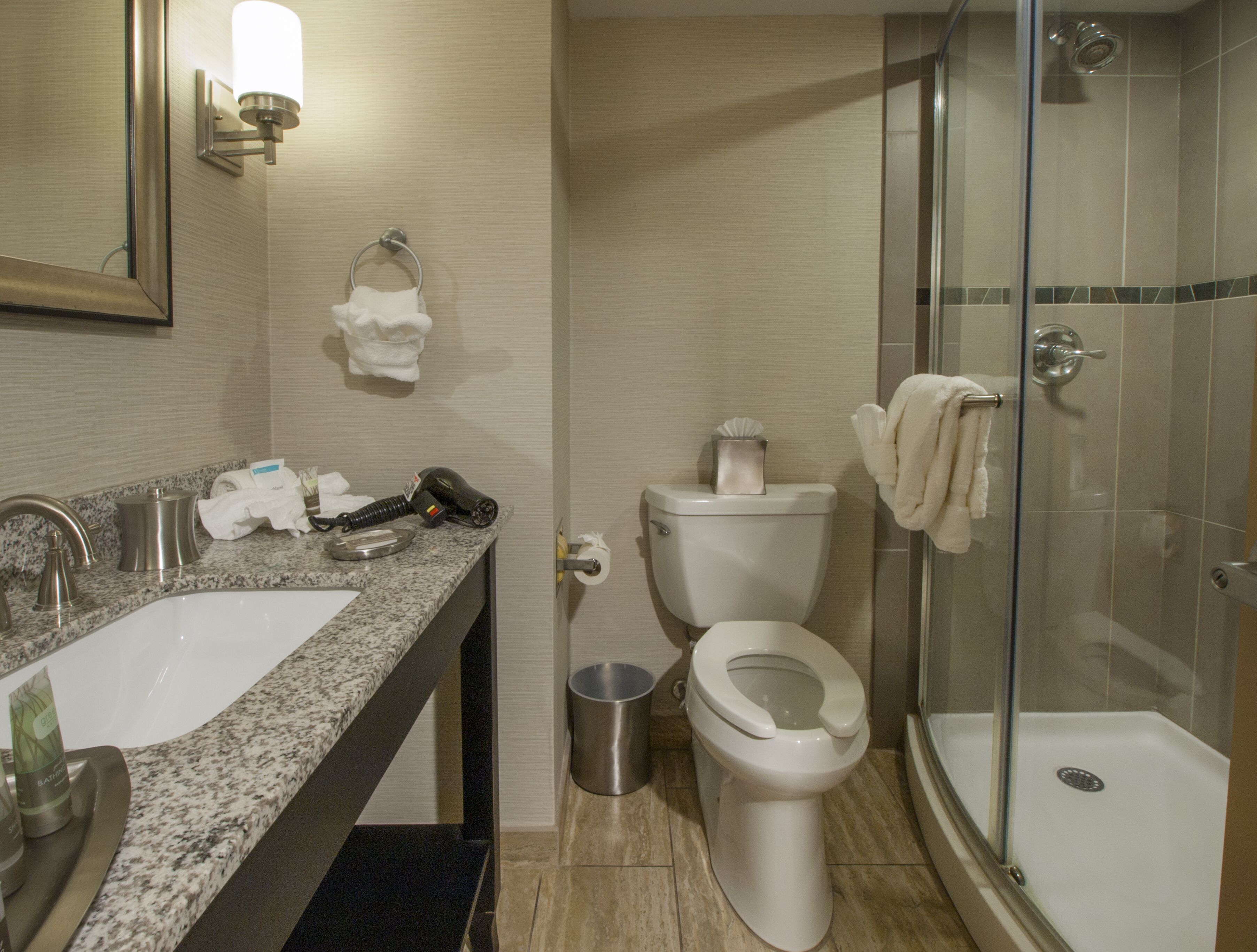 A bathroom with a sink, toilet, and shower.