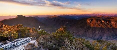 A mountainous landscape with a clear sky and a sunset.