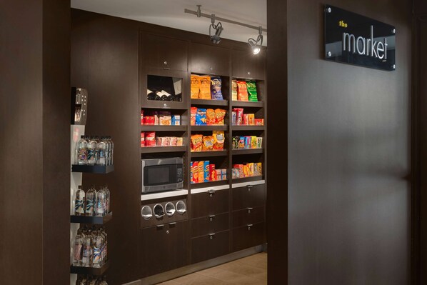 A snack vending area with various snack options and a microwave.