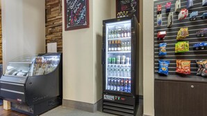 A vending machine with a glass front, a refrigerated display case, and a snack shelf.