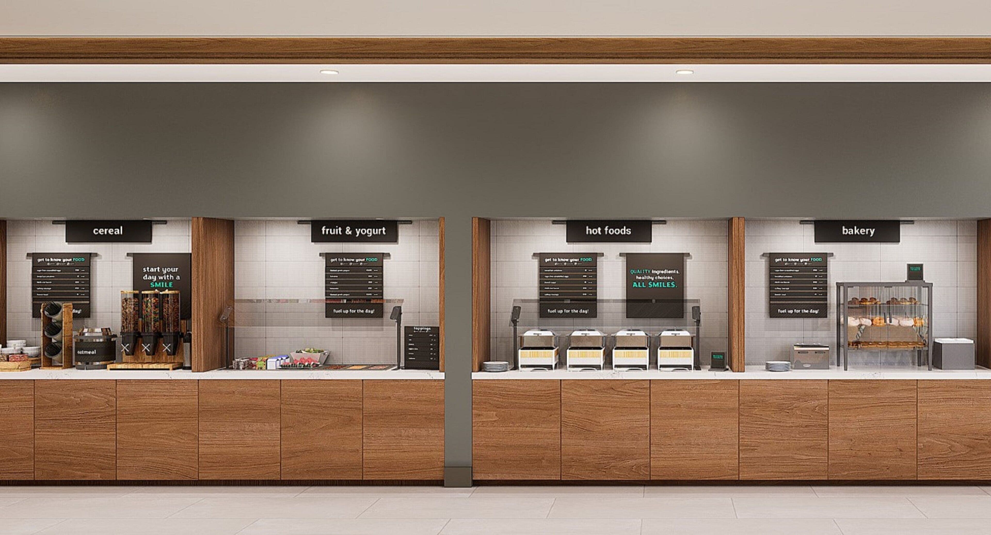 A food counter with sections labeled 'cereal', 'fruit & yogurt', 'hot foods', and 'bakery'.