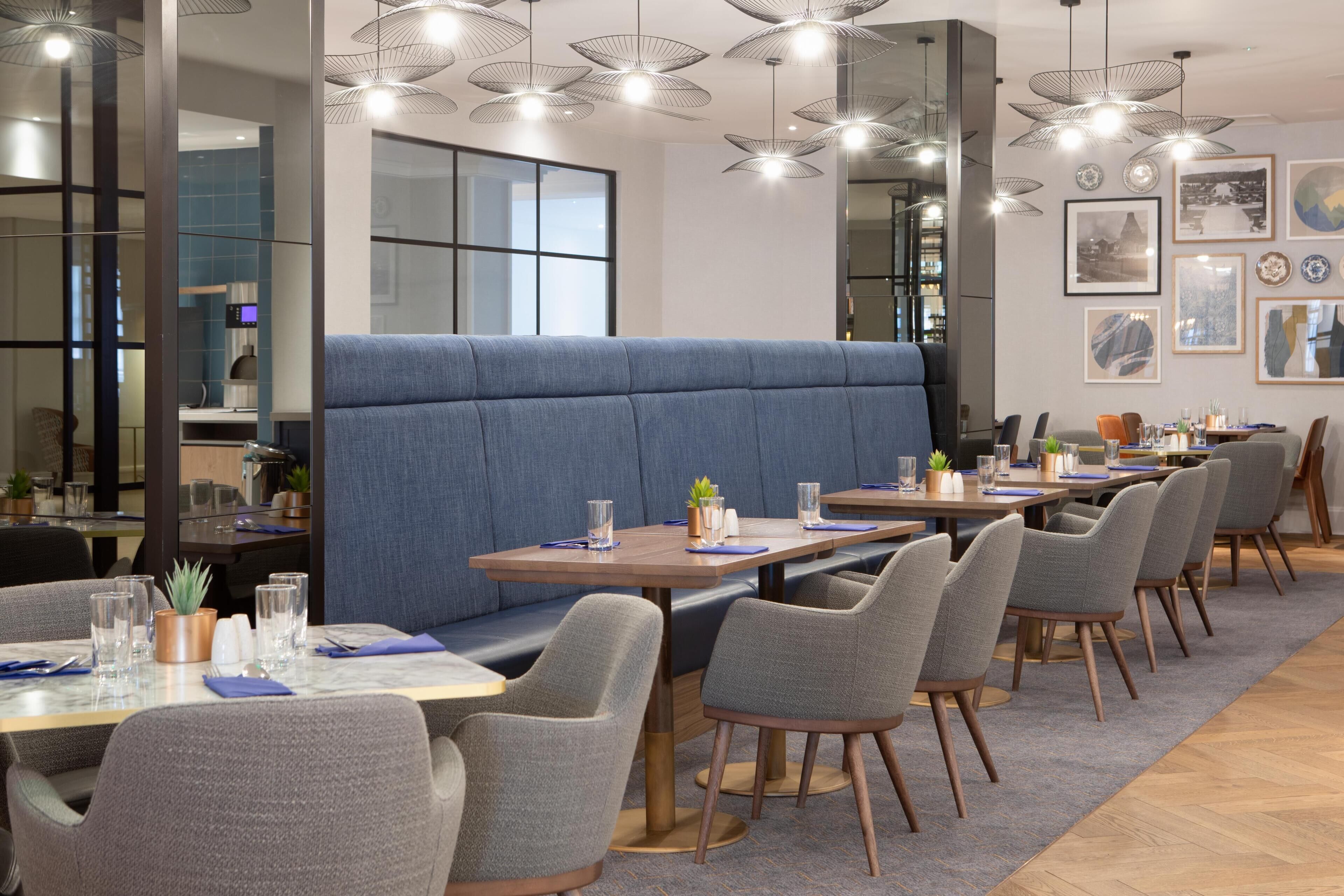 A restaurant with booths, tables, and chairs.