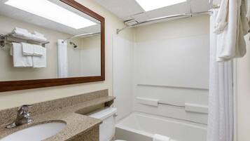A bathroom with a sink, toilet, and bathtub.
