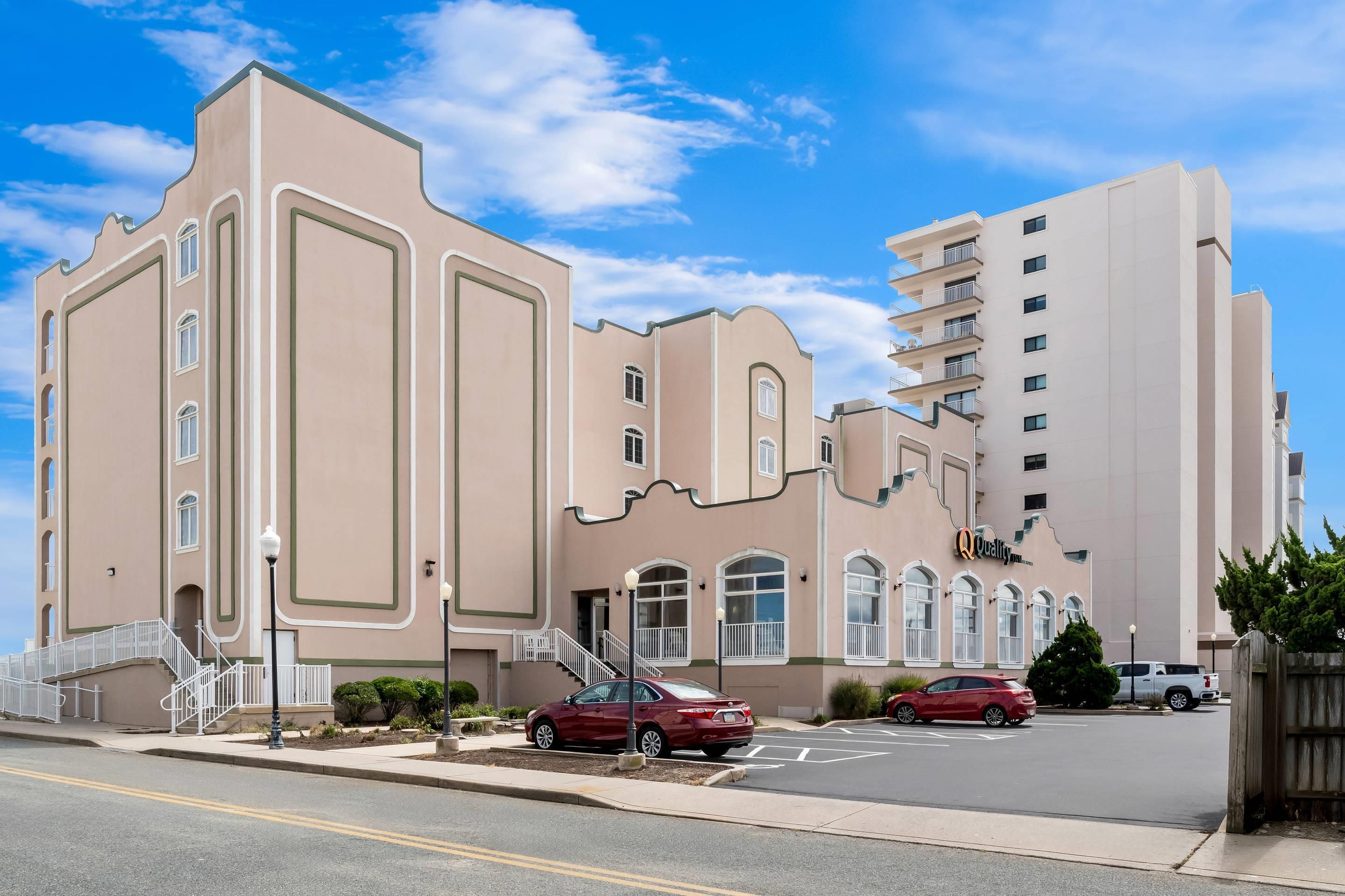 A multi-story building with a unique architectural design, featuring large windows and a central staircase.