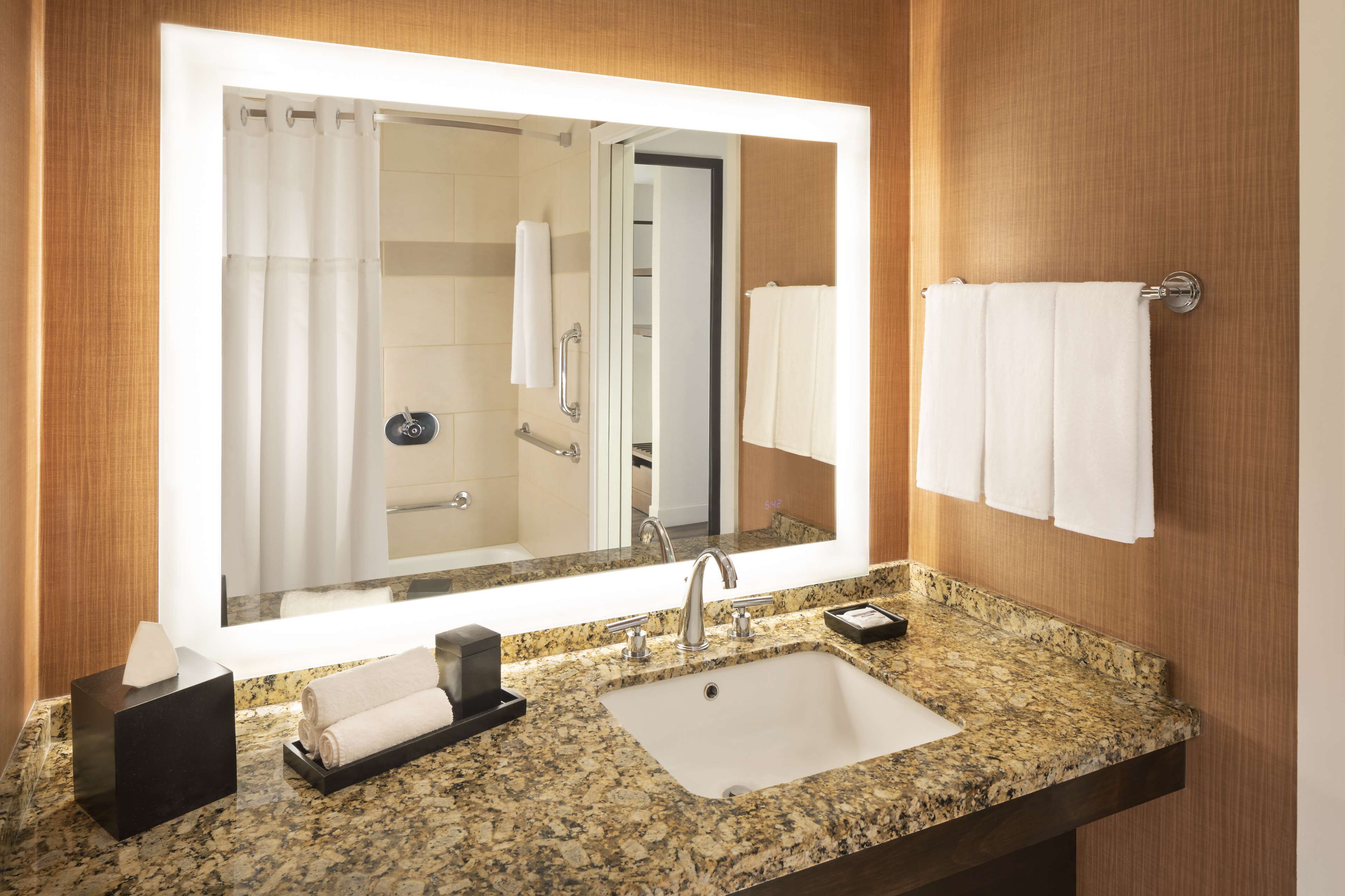 designer toiletries, hair dryer, towels