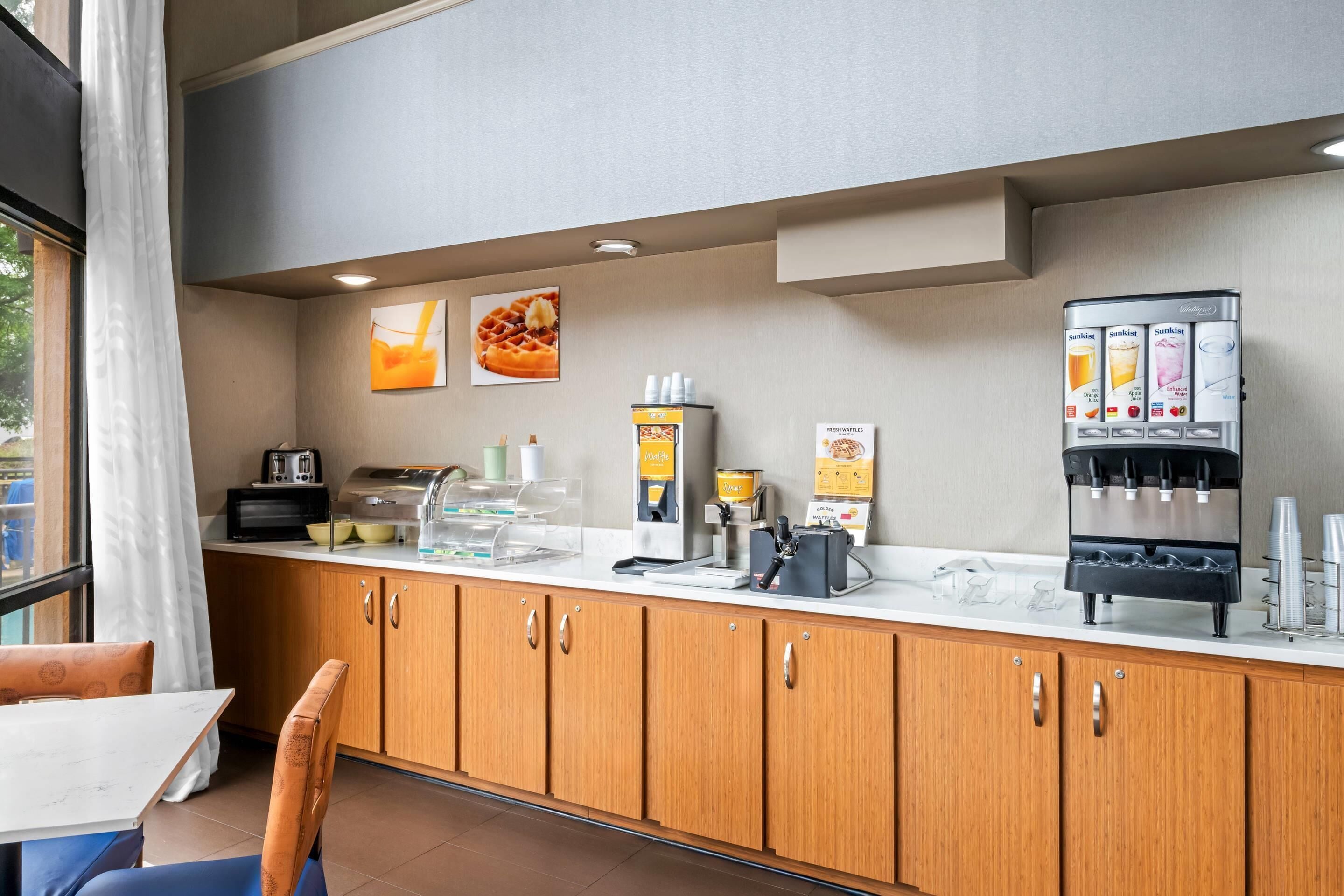 A modern kitchen area with a coffee machine, a microwave, and a toaster.