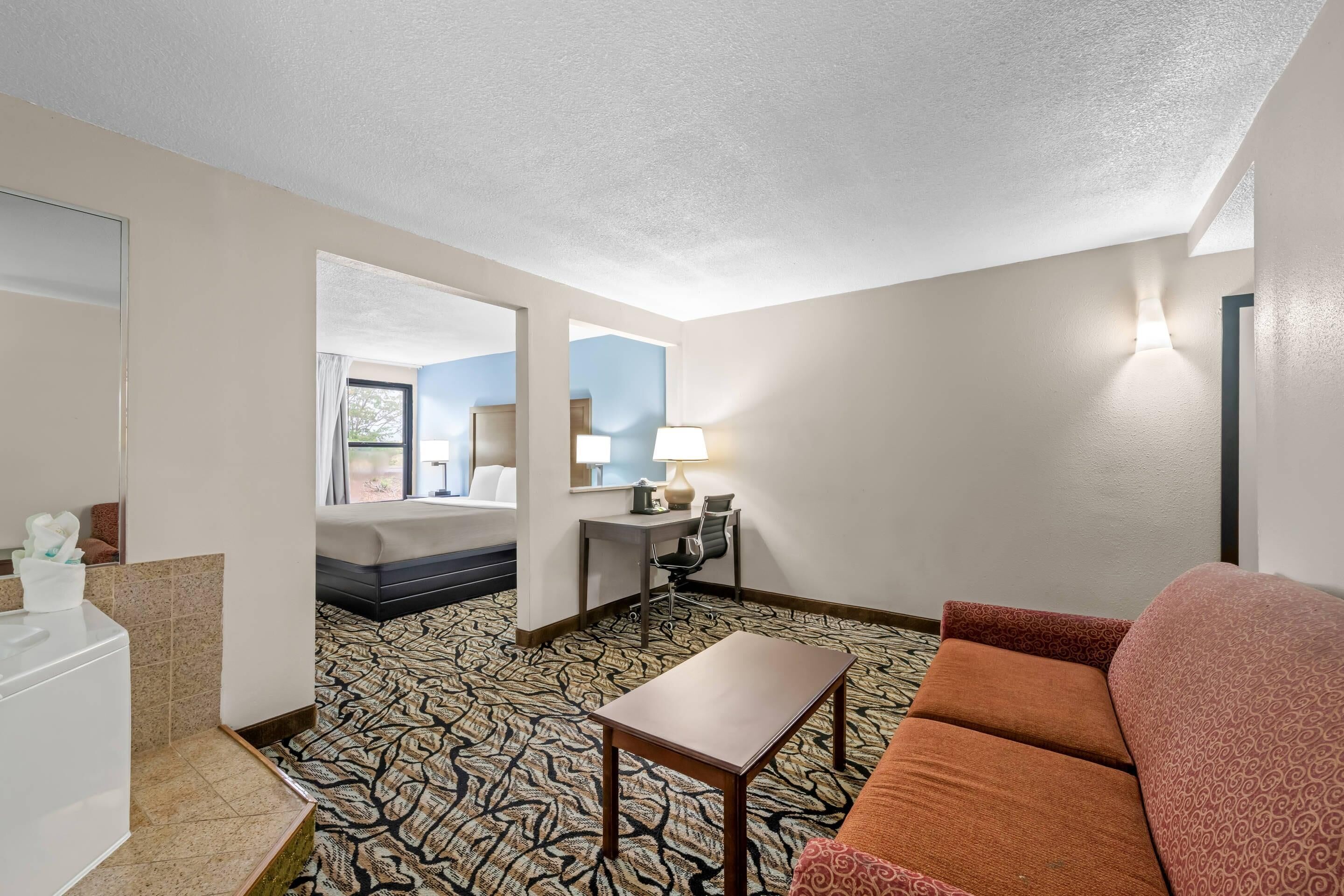 Premium bedding, desk, laptop workspace, blackout drapes