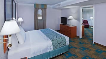 A hotel room with a bed, a television, a dresser, and a chair.