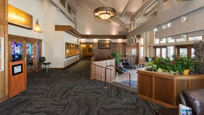 A spacious lobby with a marble floor, wooden reception desk, and a large window offering a view of the city. - KwaTaqNuk Resort & Casino (Polson)