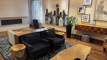 A modern living room with a sectional sofa, a coffee table, and a fireplace.