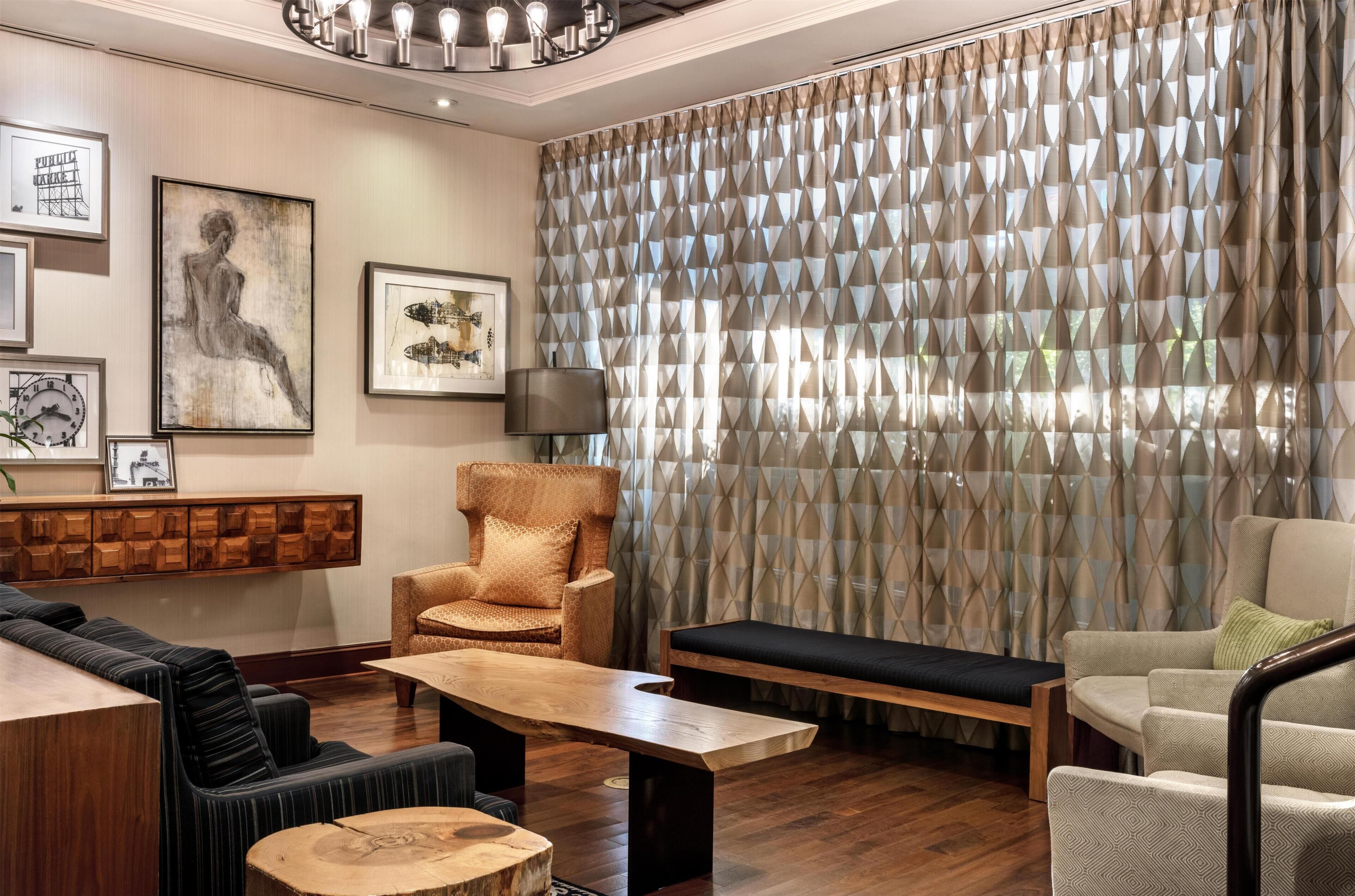 A modern living room with a sofa, armchair, and a wooden coffee table.
