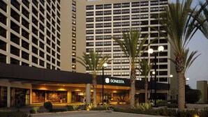 A hotel with a modern facade, featuring a prominent 'SONESTA' sign at the entrance.