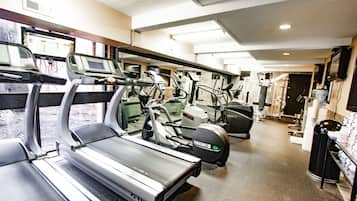 A gym with treadmills, ellipticals, and stationary bikes.