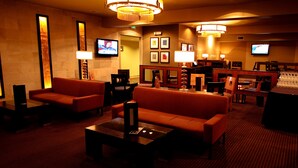 A hotel lobby with sofas, tables, and a bar area. - Mirabeau Park Hotel & Convention Center (Spokane Valley)