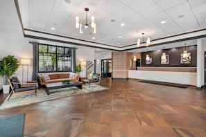 A spacious lobby with a reception desk, seating area, and large windows. - Wyndham Bloomington - Mall of America (Bloomington)