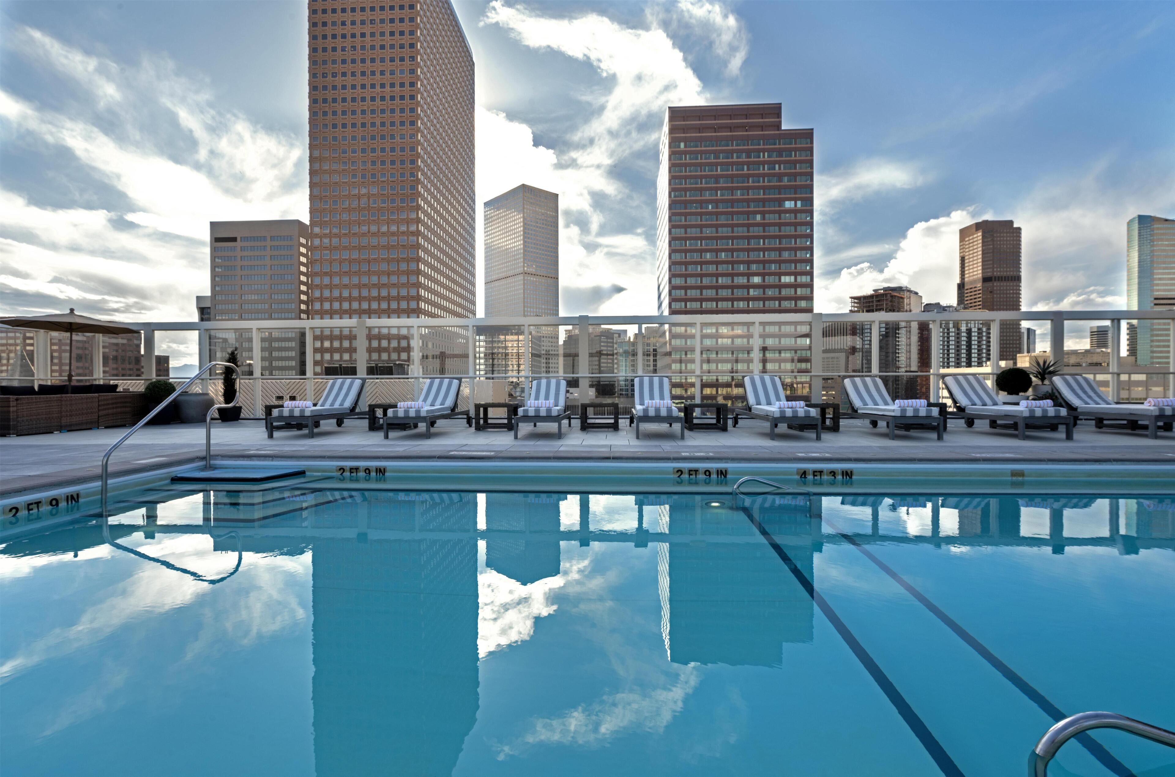 Outdoor pool, a heated pool, pool umbrellas, pool loungers