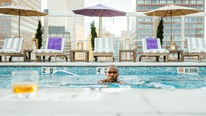 A pool area with lounge chairs and umbrellas, a 'NO DIVING' sign, and a '2 FT 9 IN' depth marker. - Warwick Denver (Denver)