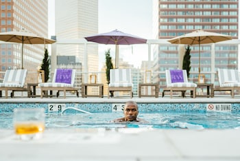 Outdoor pool, a heated pool, pool umbrellas, sun loungers at Warwick Denver
