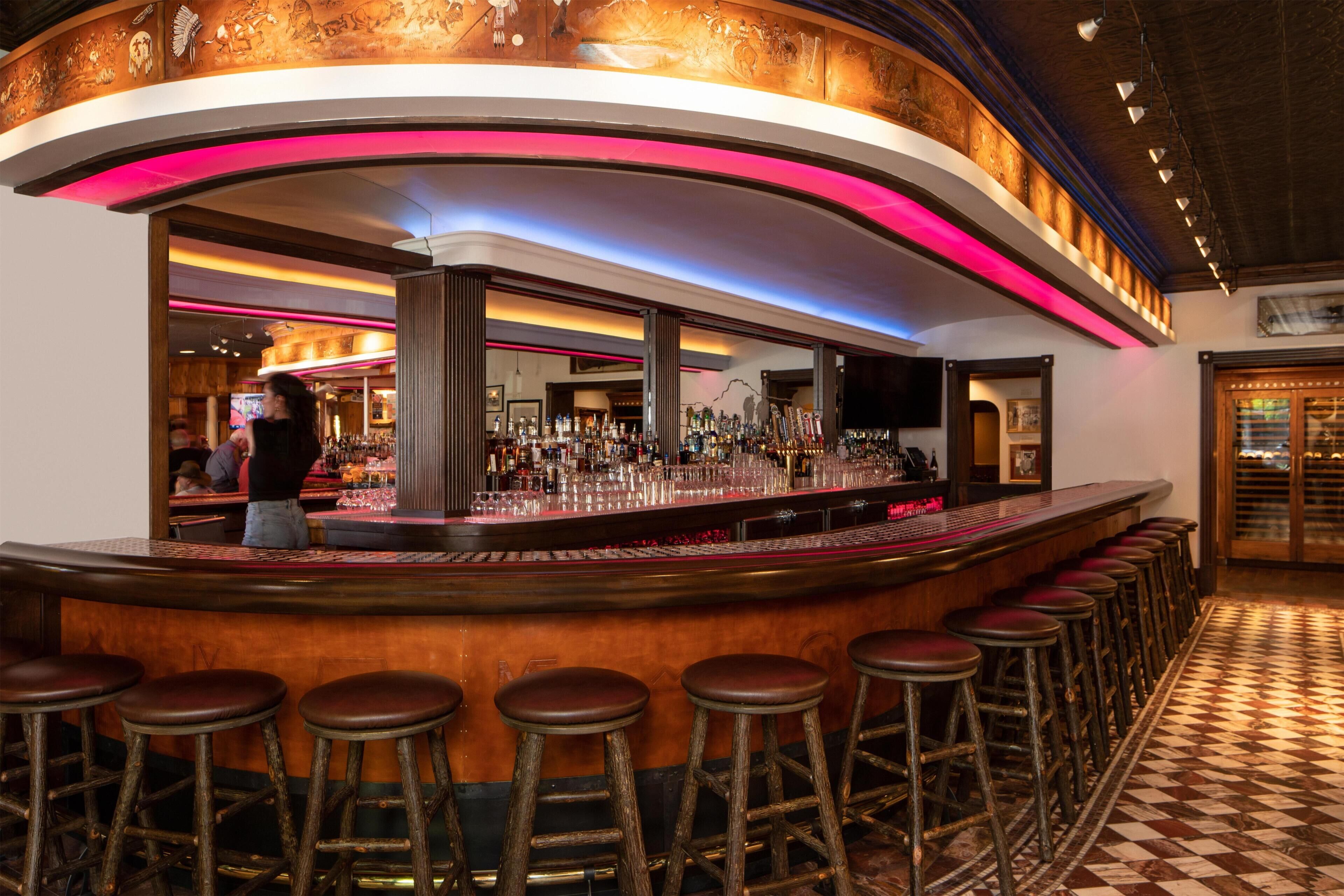 A bar area with stools, a counter, and a checkered floor.