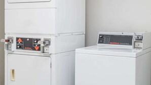 A commercial dryer and a commercial washer side by side. - Days Inn by Wyndham Bedford (Bedford)