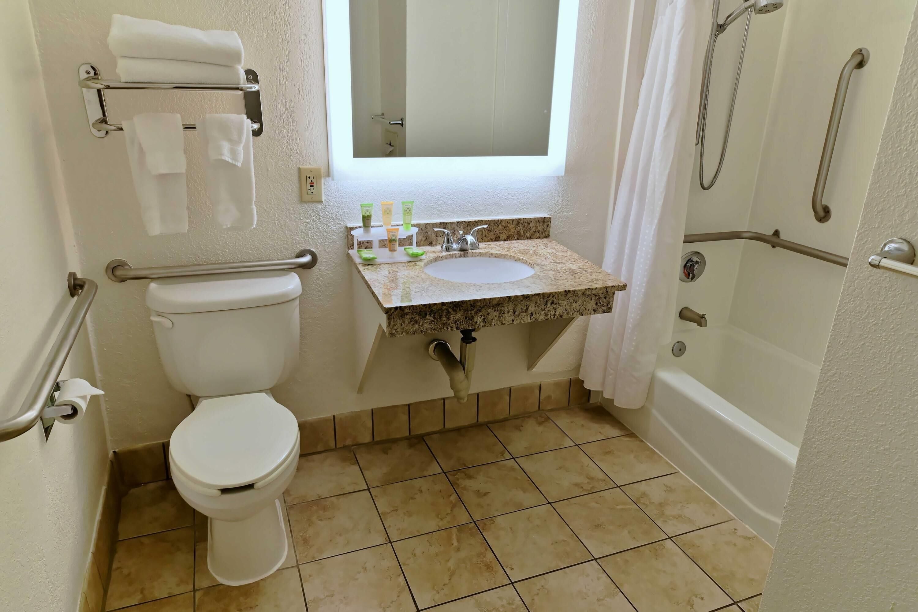 A bathroom with a toilet, sink, and bathtub.
