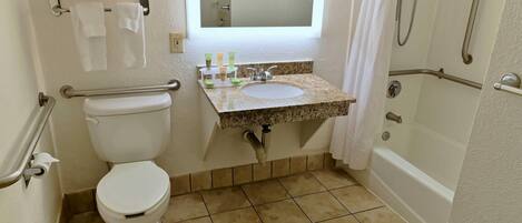 A bathroom with a toilet, sink, and bathtub.