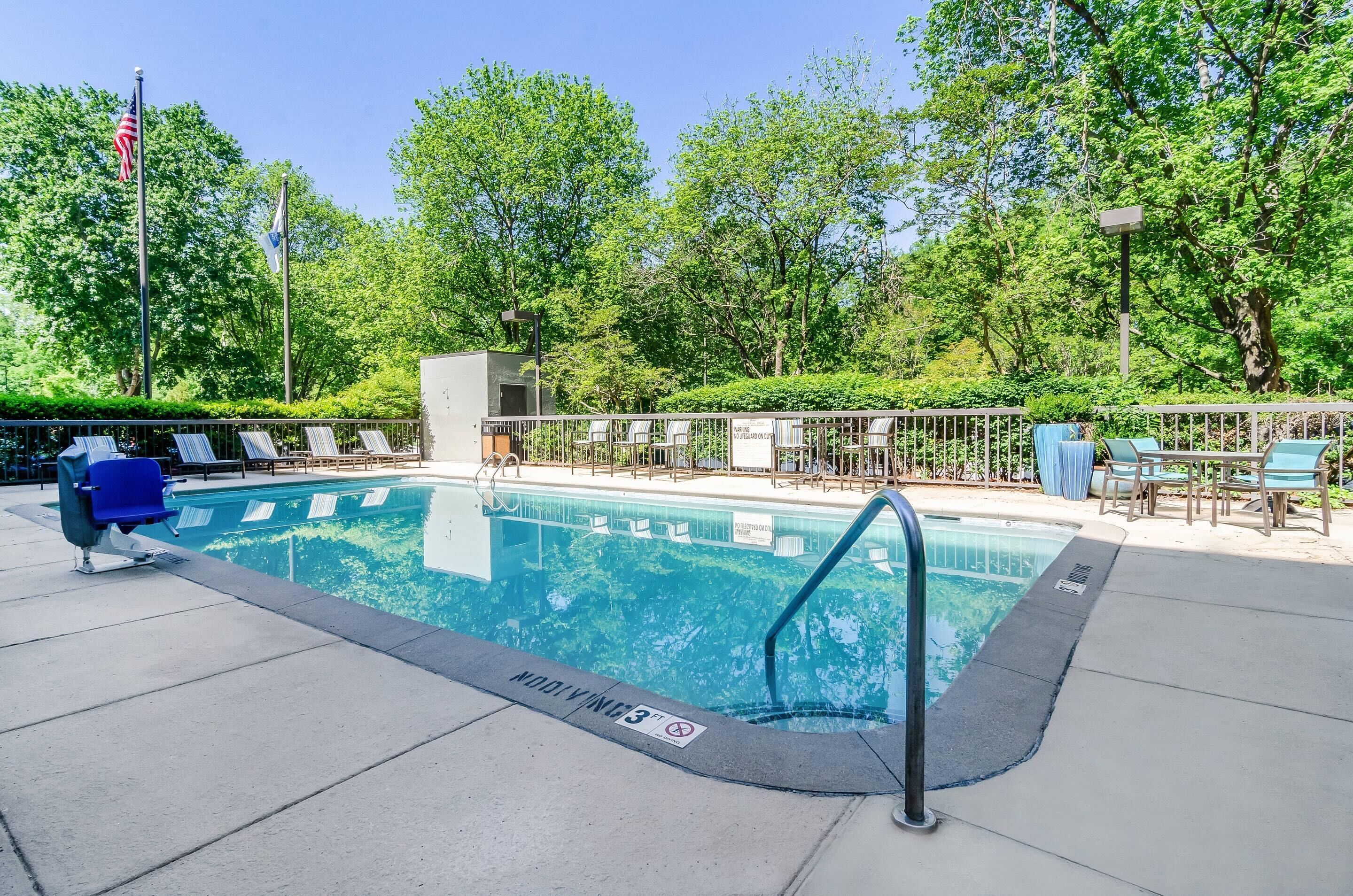 Seasonal outdoor pool, open 10:00 AM to 8:00 PM, pool umbrellas