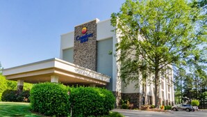 A Comfort Inn hotel with a modern facade, a covered entrance, and well-maintained landscaping.