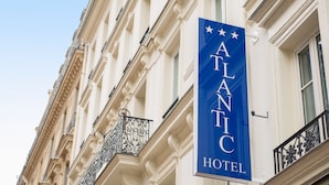 A hotel sign with the name "ATLANTIC HOTEL" and decorative stars. - Atlantic Hotel (Paris)