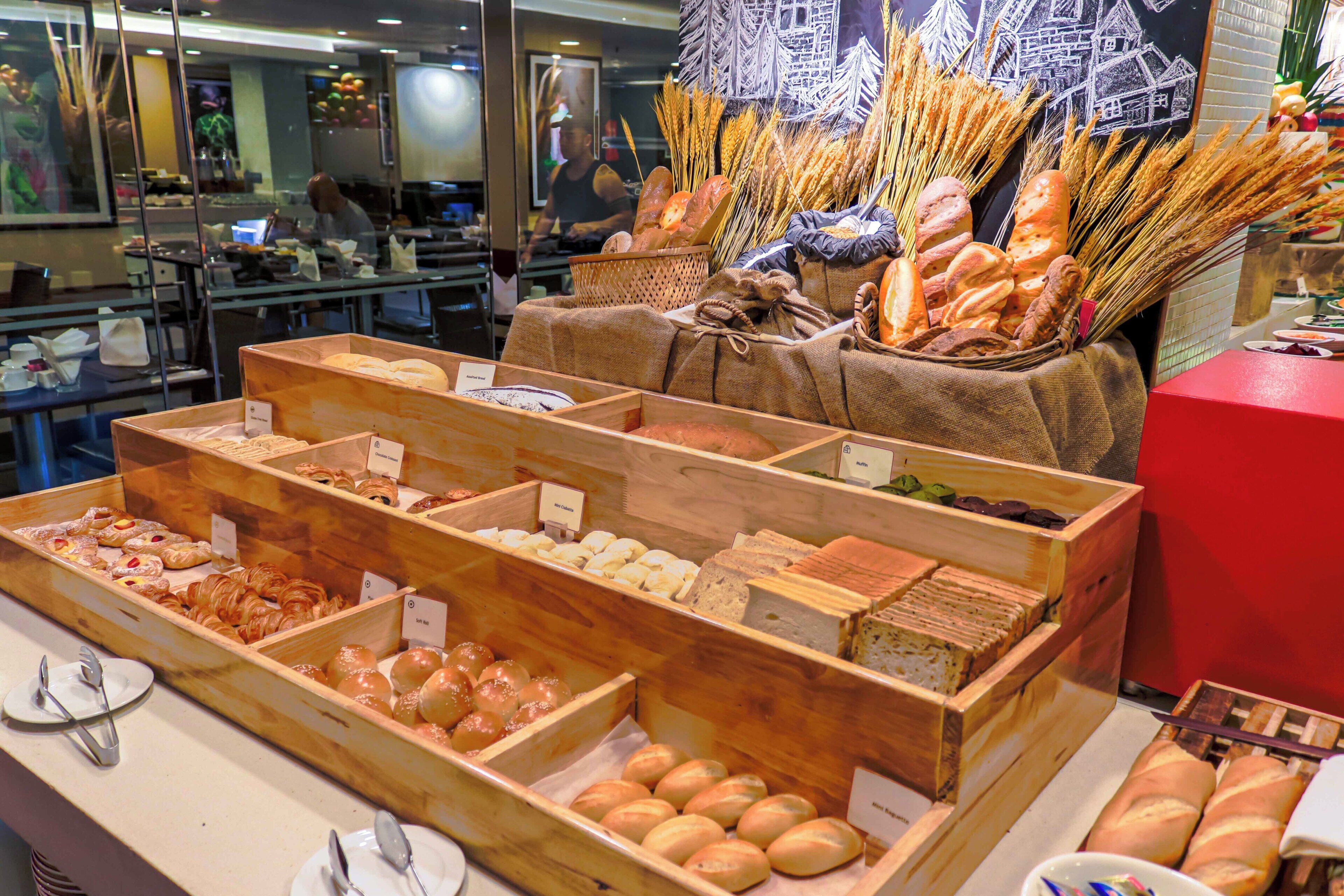 A bakery display with various breads and pastries.