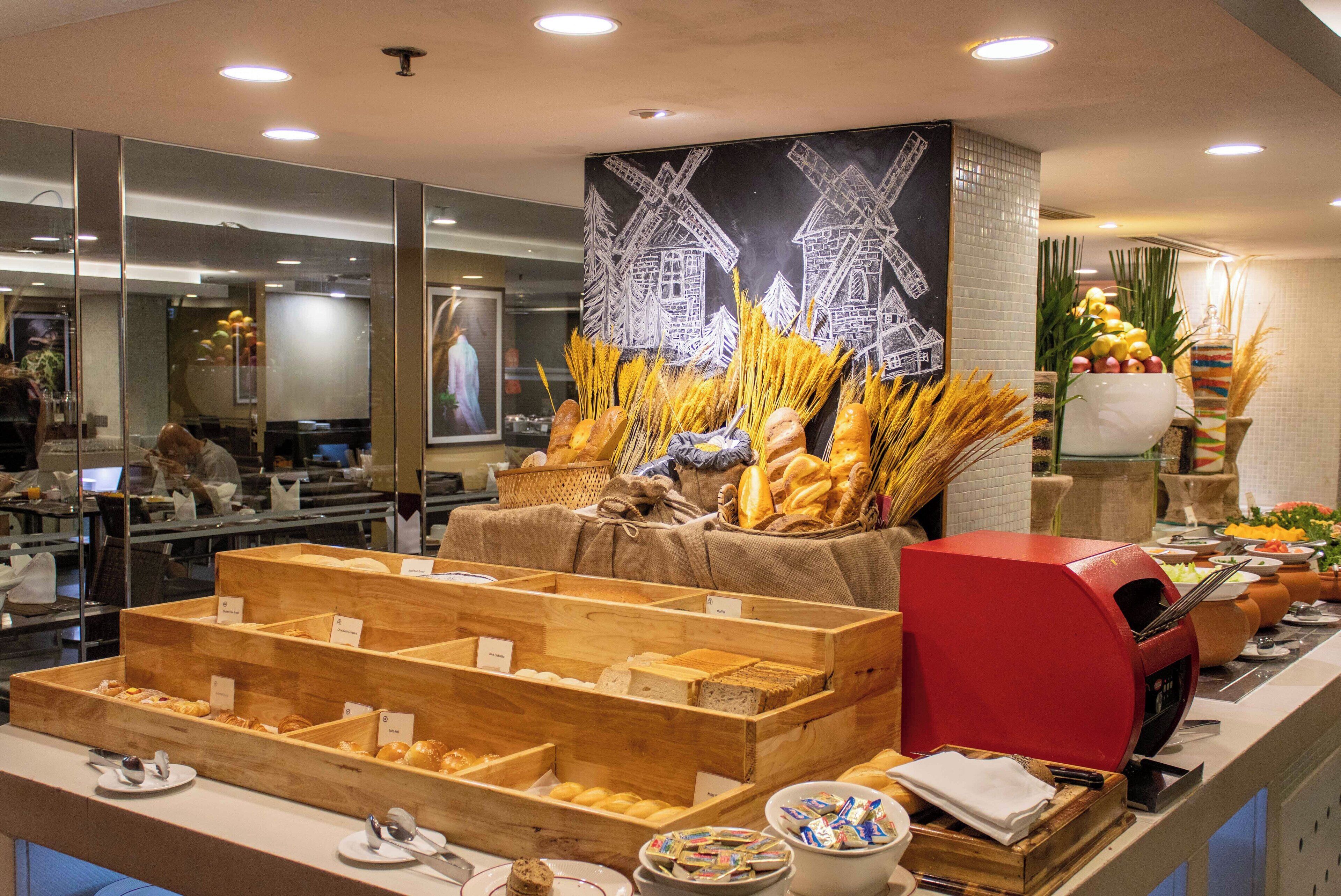 A buffet area with various food items and a red coffee machine.