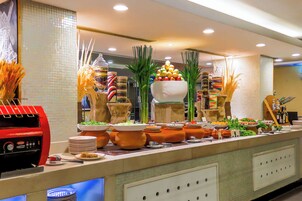 A buffet setup with various food items and decorative elements.