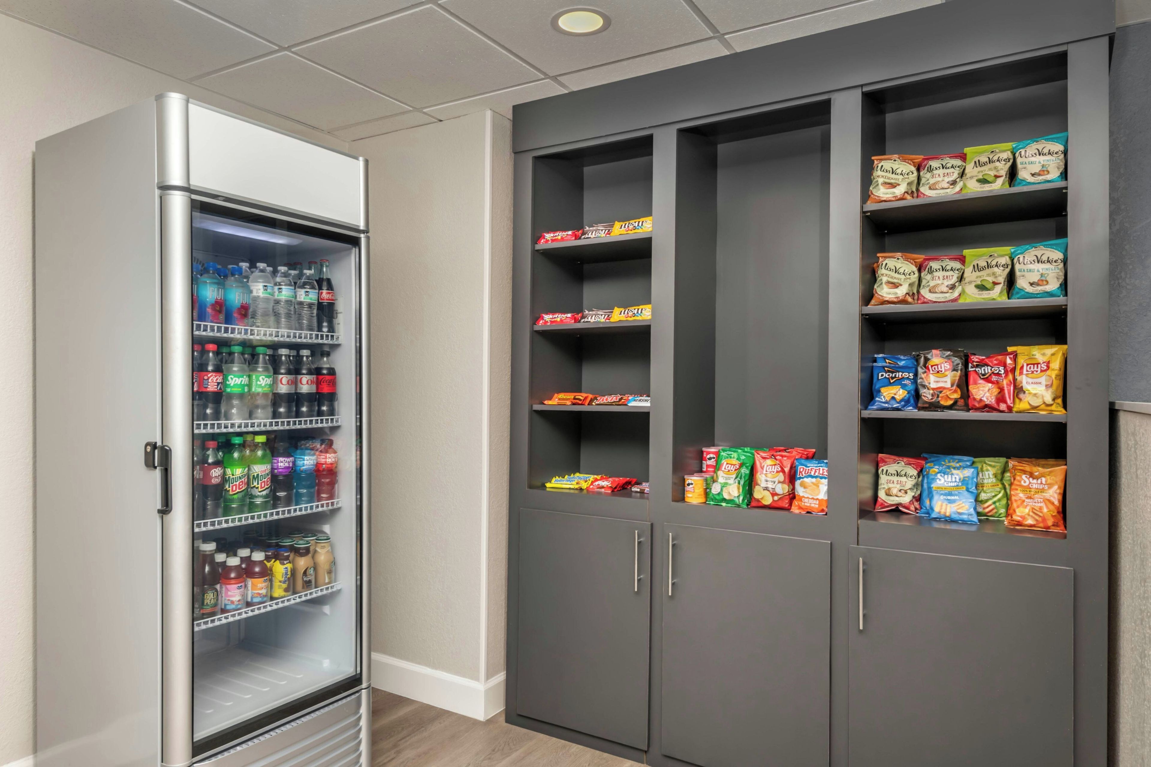 A vending machine stocked with various beverages and snacks, including chips and sea salt snacks.