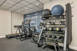A gym with treadmills, a wall-mounted weight rack, and exercise balls. - City Express by Marriott I-10 West Energy Corridor (Houston)