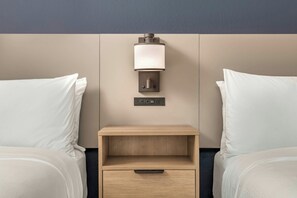 A hotel room with two beds, a nightstand with a lamp, and a power outlet. - City Express by Marriott I-10 West Energy Corridor (Houston)