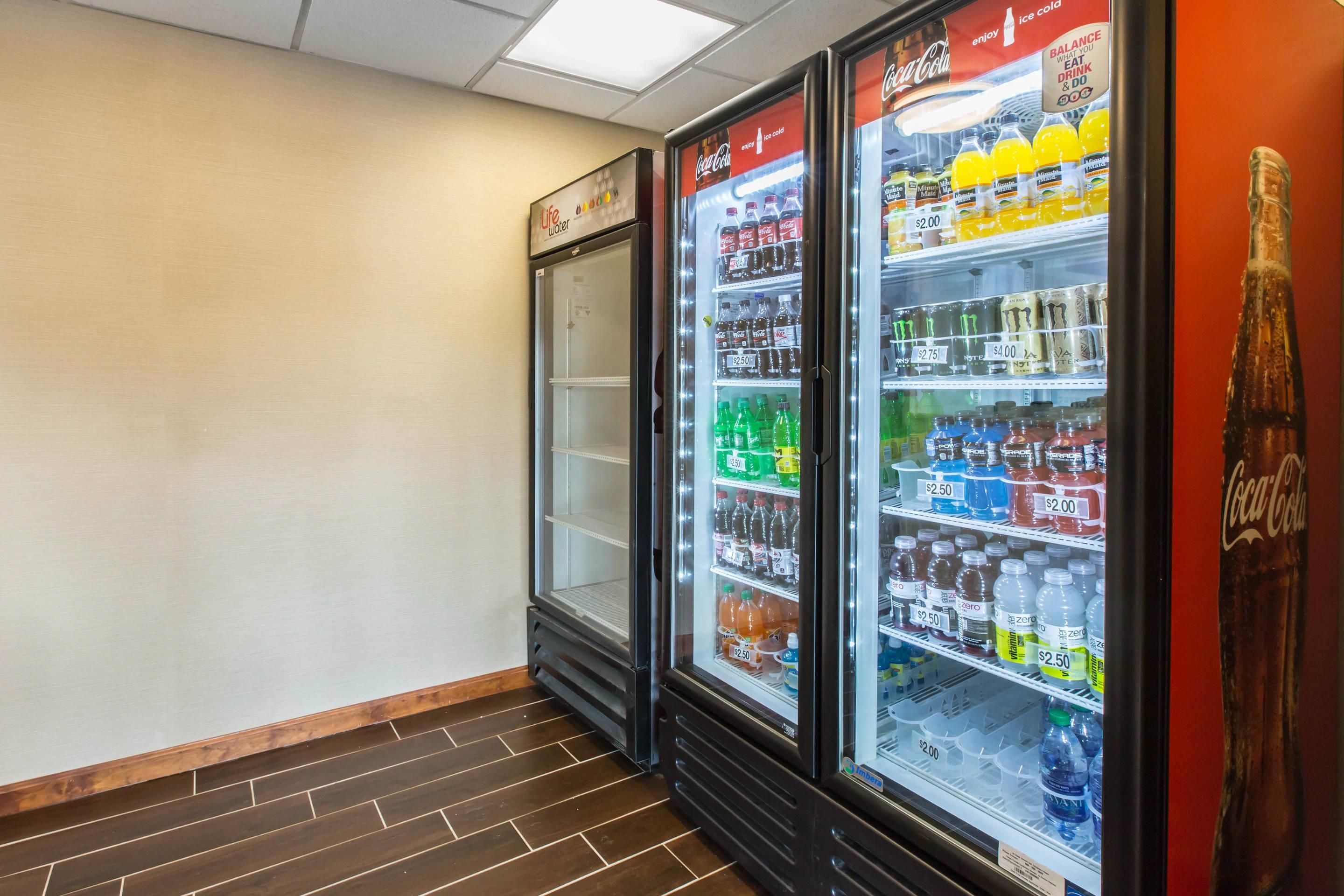 A vending machine area with various beverage options and price tags.