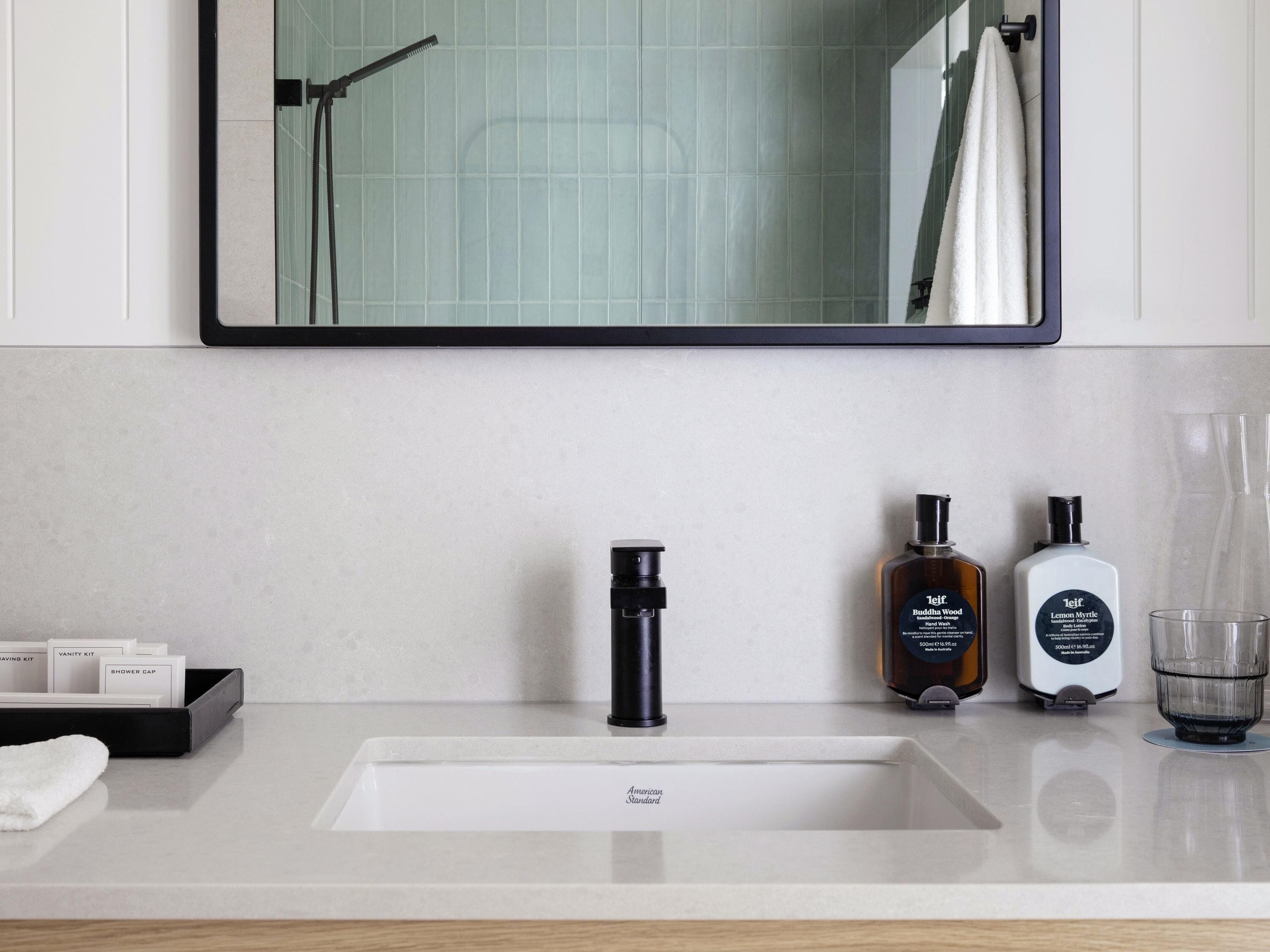 Designer toiletries, hair dryer, slippers, towels