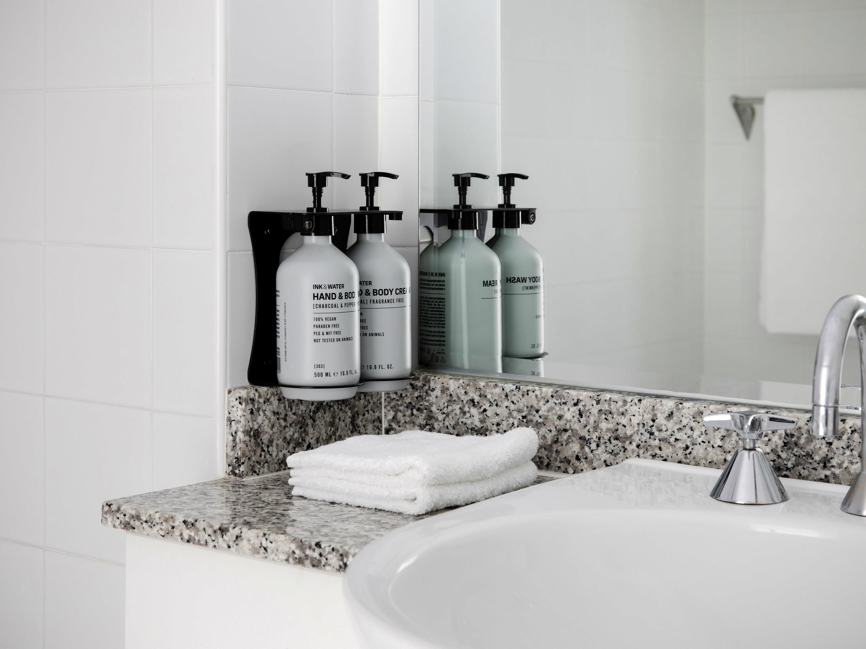 Designer toiletries, hair dryer, slippers, towels