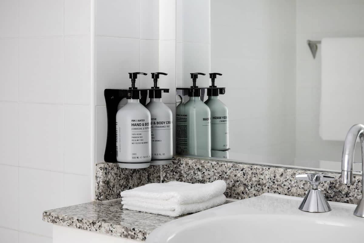 Designer toiletries, hair dryer, slippers, towels