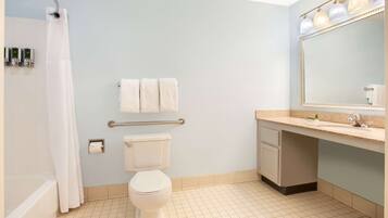 A bathroom with a bathtub, toilet, and sink.