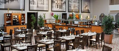 A restaurant with multiple dining tables and chairs, a coffee station, and a bar area.