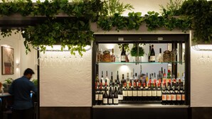 A bar area with a wine display and a person in the background. - Radisson Blu Hotel, London Euston Square (London)