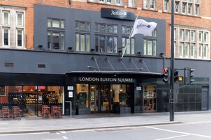 A building with a sign reading "LONDON EUSTON SQUARE" and a flag.