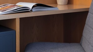 A modern room with a wooden desk, a grey chair, a round mirror, and a vase. -  STG Hotel London Oxford Street (London)