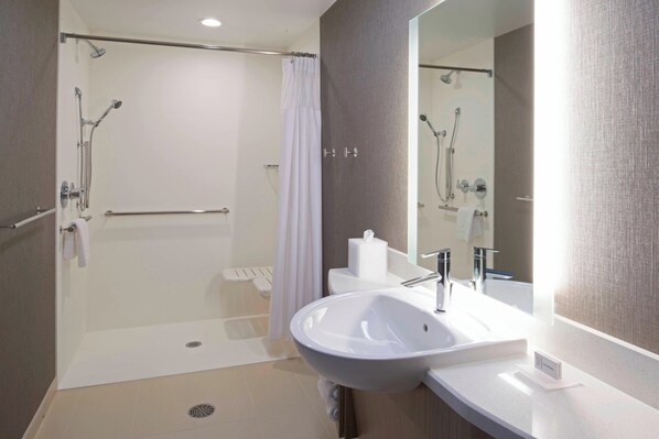 A modern bathroom with a glass-enclosed shower, a white sink, and a large mirror. - SpringHill Suites by Marriott East Lansing University Area (East Lansing)
